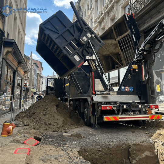 Black MTS suction excavation truck operating in a narrow urban street, removing soil through non-destructive suction excavation without closing the road or affecting surrounding infrastructure.
