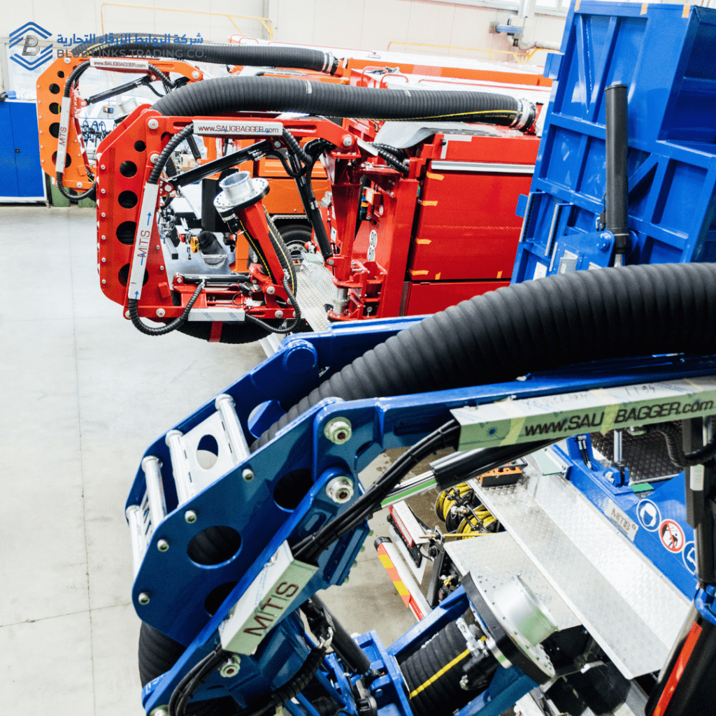 Close-up view of MTS suction excavator boom systems and technical components inside manufacturing facility.
